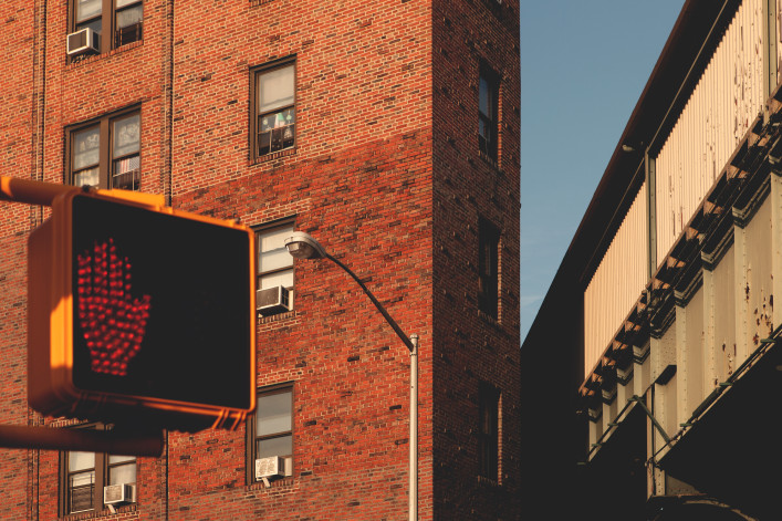 Urban city streets in the outer boroughs of New York City. A railroad apartment near a bridge in Queens, New York CIty.